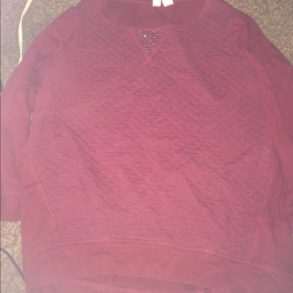 a sweater that has rhinestones on the top